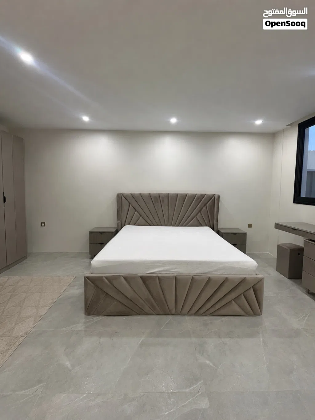 Large bed with bed tables and dressing table