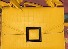 Yellow leather bag with brown linen interior