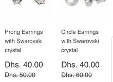 two earrings with swarovski crystal each of them is 40 dirham