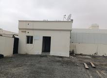 Industrial land for rent in Al misfah with a boundary wall and a guard room أرض صناعية مسورة المسفاة