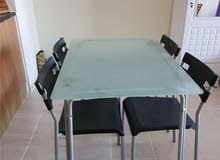 Glass top dining table with four chairs for 200 AED Glass top dining table with four chairs for 200 AED