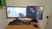 computer for gaming and office use with 2 monitors and keyboard and mouse