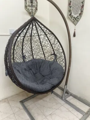 An hanging chair  suspended from a curved stand in excellent condition