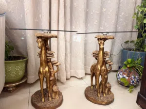 Two golden giraffe tables