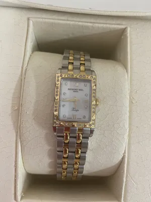 A Raymond Weil silver and gold ladies watch with 40 small carat diamonds.Its only been used once.