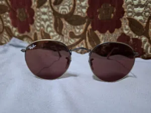 نظارات شمسيه من راي بان بلون قريب للوردي ray ban round metal rb3447 167/2k