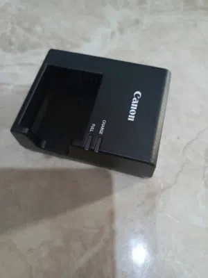 شاحن كاميرا كانون اصلي  بحالة الوكالة والجديد