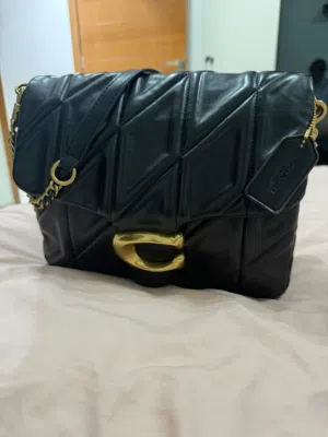 Coach Bag black quilted with the C logo .