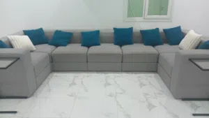 Sectional sofa with built in storage. Plus 2 glass end tables for 30 KWD.