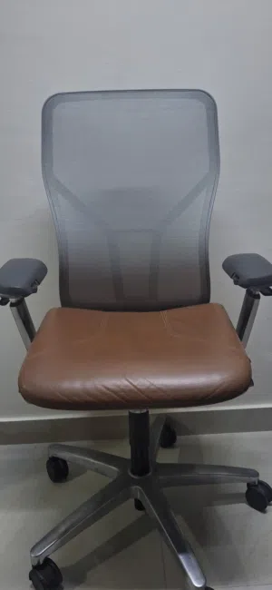 Allsteel Acuity task chair with a light brown seat and mesh back