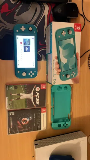 43BD Nintendo switch light with box and 2 games good condition everything working