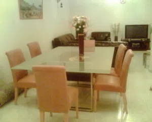 Huge glass top dining table with leather chairs