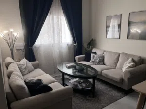 Living room furniture (sofas, coffee table, lamp, curtains, picture frames)