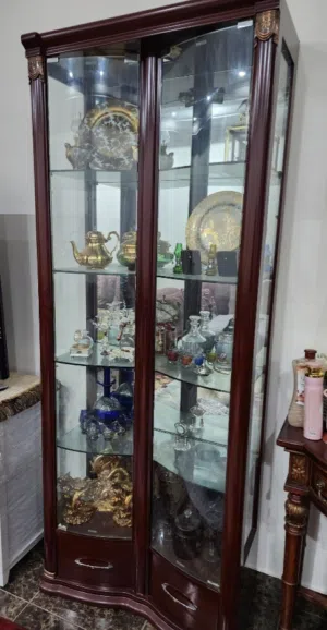 اثاث غرفة معيشة خزانتين باب زجاج مع درجين بالأسفل وطاولة وسط مع طاولتين جانبيتين