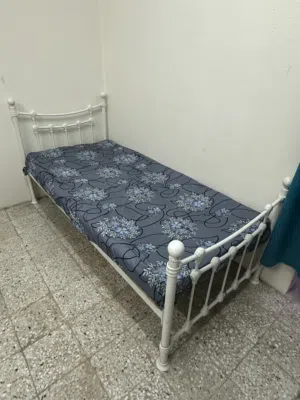 White metal bed with mattress