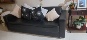 Three seater black leather sofa