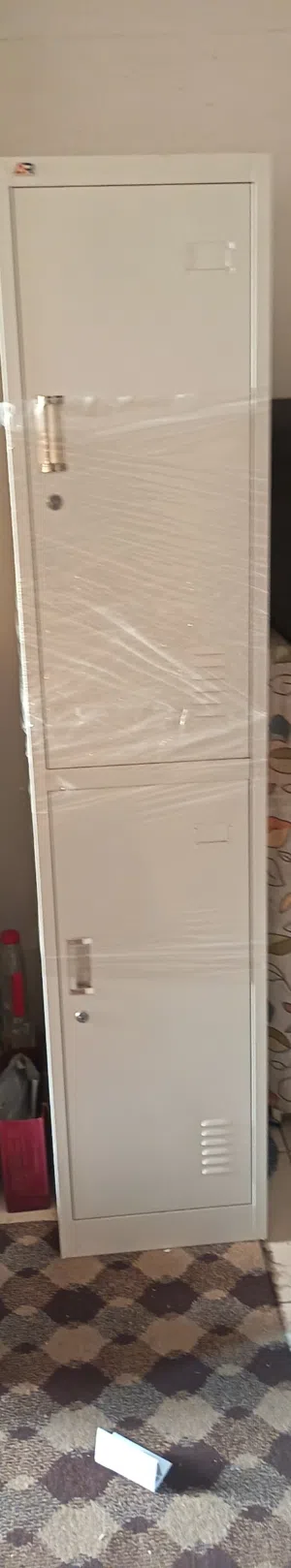 One big wodden cabinet white neat and clean.