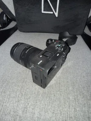 كاميرا سوني a6700 مع عدسة سيقما 18mm-50mm ومع حماية small rig وذاكرة lexar professional 128GB 2000x