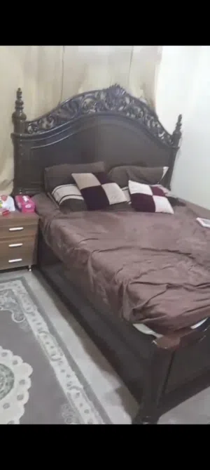 wooden bed with mattress