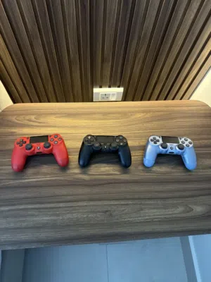 3 ps4 controllers red black and blue