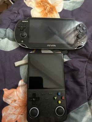 New PlayStation vita black color with charger and R36 ultra retro gaming handheld