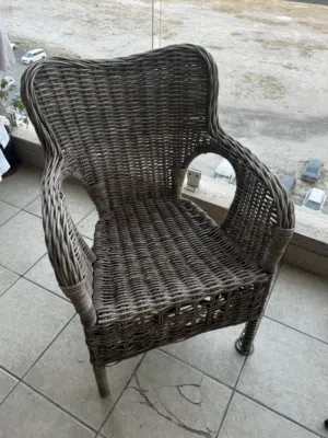 Two rattan chairs with a small table in good condition