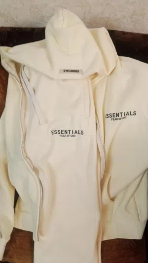 Based on the image provided, these are Fear of God Essentials cream/beige hoodies and a matching tra