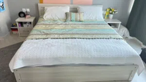 Full bed with two bedside tables and a mirrored dresser