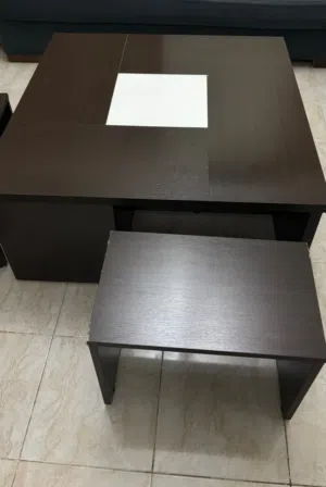 طاولة صغيرة . معها 4 تربيزات صغيرة . لونها بني .قباني متينة .