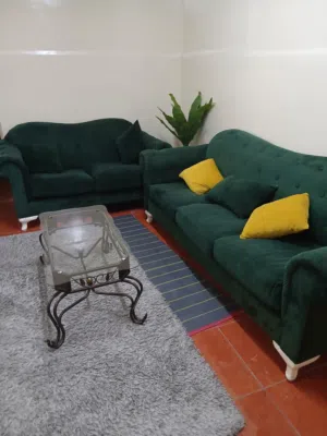 Green velvet two seater,three seater and glass table