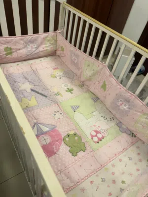 Sturdy baby cot in good condition with mattress and side rail covers included.