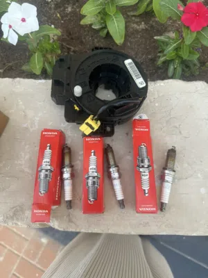 Three Honda NGK spark plugs and a Honda City/Jazz Clock Spring