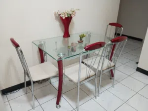 Glass-top dining table with 4 chairs (red legs, white seats)