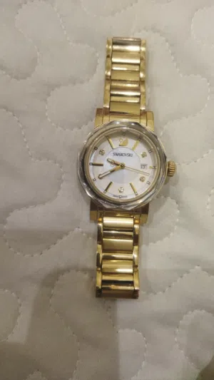 gold-tone Swarovski Octea Mini watch, reference number 999971, with a mother-of-pearl dial