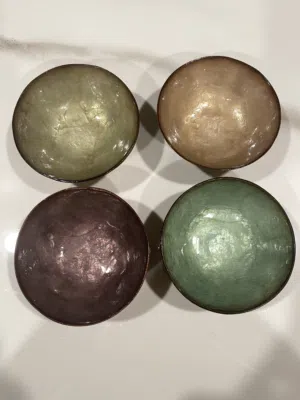 Delicate shell bowls made of capiz that capture the beauty and colorful shine of natural shells.