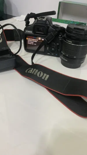 Canon EOS DSLR 1100 with 18-55mm Kit Lens, strap and charger Shutter Counter): 11,355)