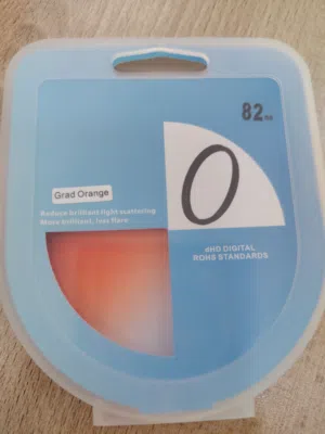 عدسة كاميرا (Grad Orange) قياس 82mm يُستخدم للتصوير لإعطاء لون دافئ وتقليل الوهج في الصور