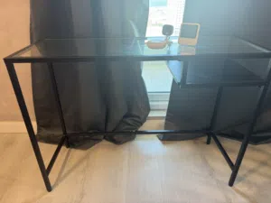 طاولة  زجاجيه من ايكيا مع رف خشب استعمال نظيف
