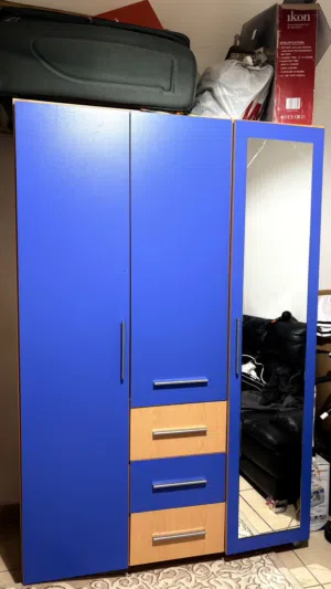 I’m selling a blue high-gloss storage cabinet with open shelves.