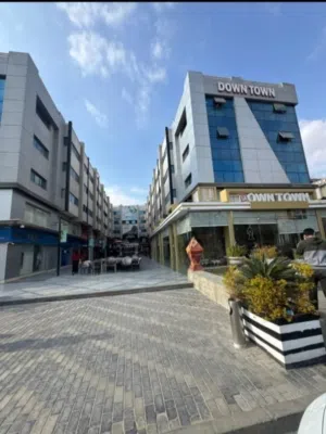محل 100م دورين للإيجار في داون تاون الشيخ زايد بجوار QNB
