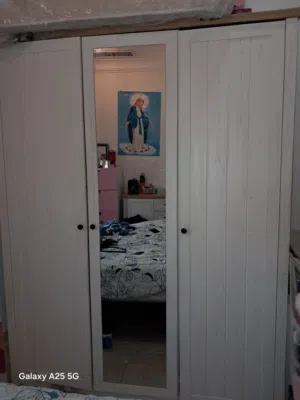 wooden wardrobe painted in white and brown and dresser.