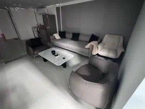 Complete office furniture package, including sofas, refrigerator, sink, and conference table..