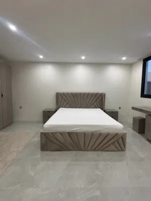 Large bed with bed tables and dressing table
