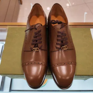 Gucci Men's Rooster Brogue Leather Derby Shoes in brown.