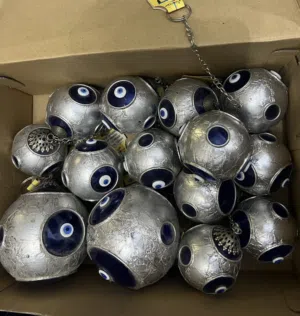 2 size metal spheres w protecting blue eyes.Silver with stones organizer.Double sided wood frame.