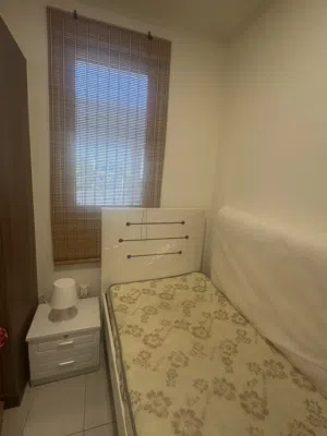 Single bed with mattress and side table