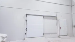 A warehouse equipped with three refrigerators for storage and space for packaging.