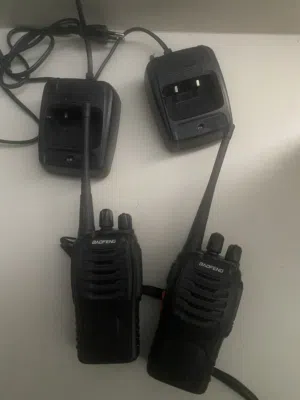 Pair of handheld Baofeng-style two-way radios with chargers