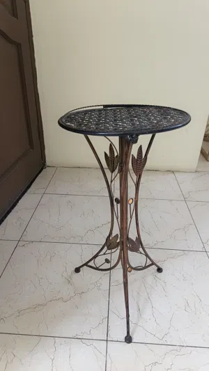 vintage-style wrought iron flower stand or side table.