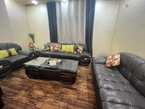 غرفه سفره مع دنسوار خشب صولد ثمانيه كراسي لون جوزي مع طقم كنب جلد لون اسود